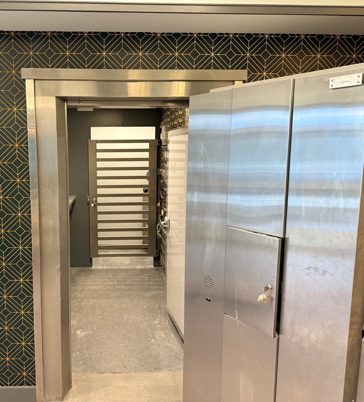 The bank vault door standing open, with the barred day gate visible inside